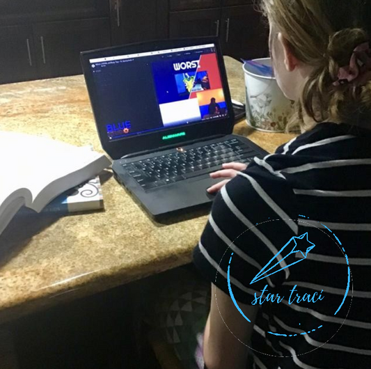 girl sitting at laptop doing homeschool, quarantine